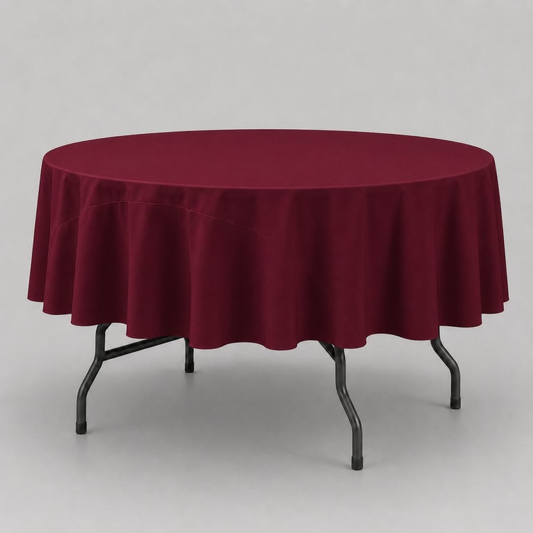 Round table with dark red tablecloth and metal folding legs against gray background