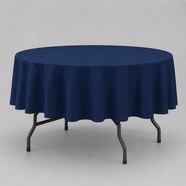 Round table with dark blue tablecloth and metal folding legs against gray background
