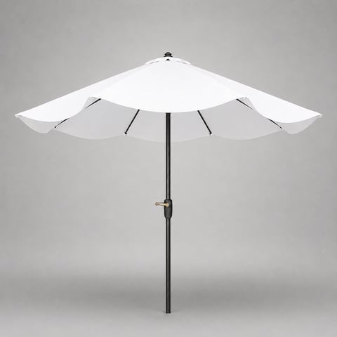 Colorful striped umbrella providing shade in a sunny outdoor setting with vibrant greenery and clear blue sky