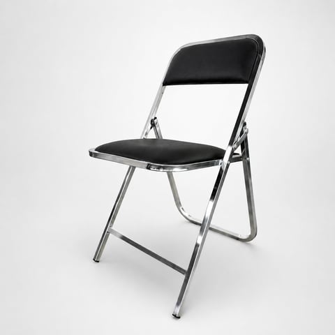 Black and silver folding chair with padded seat and backrest against white background